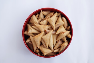A bowl of delicious triangular pastries.