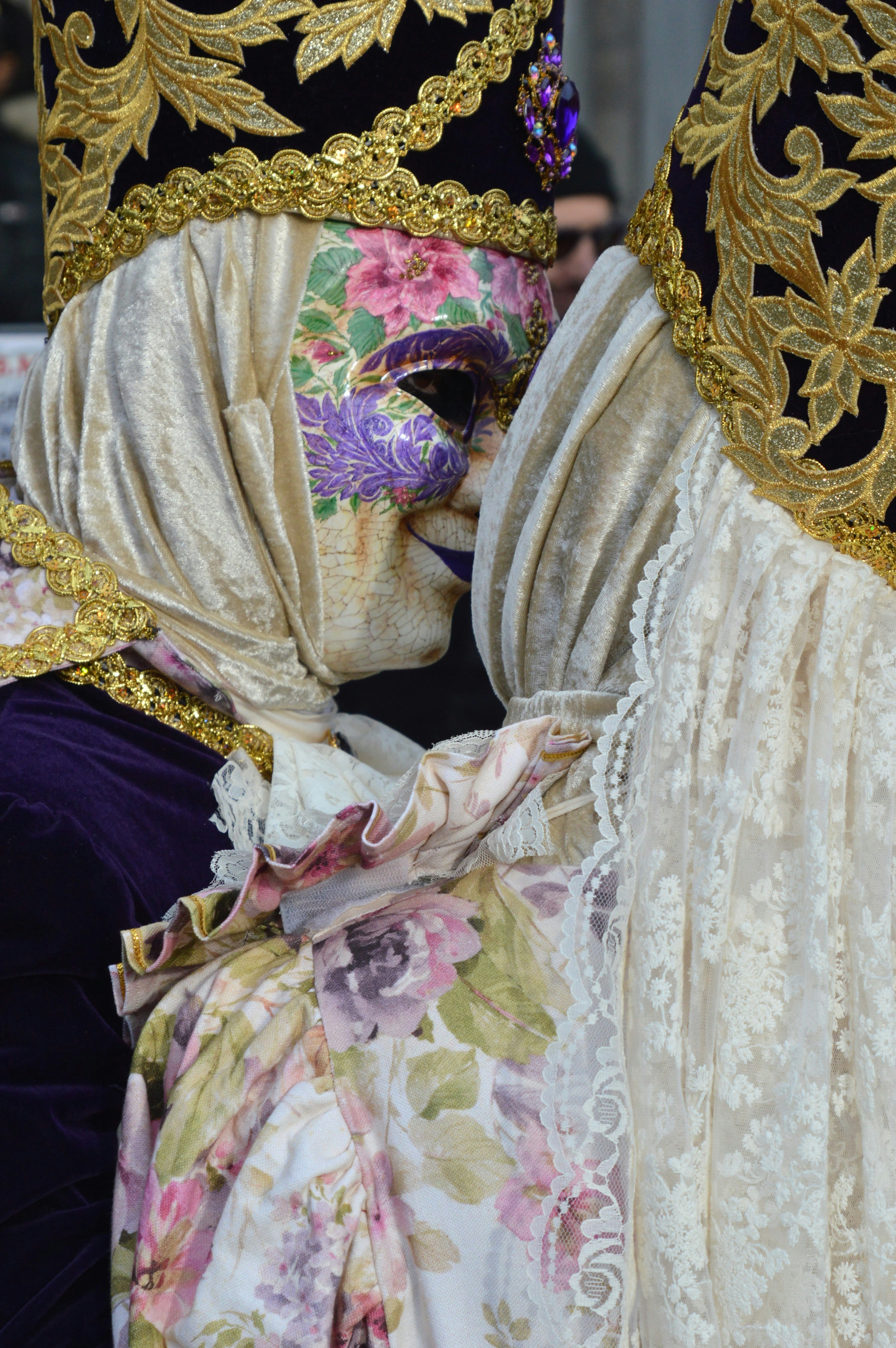 Two masked people share a close moment.