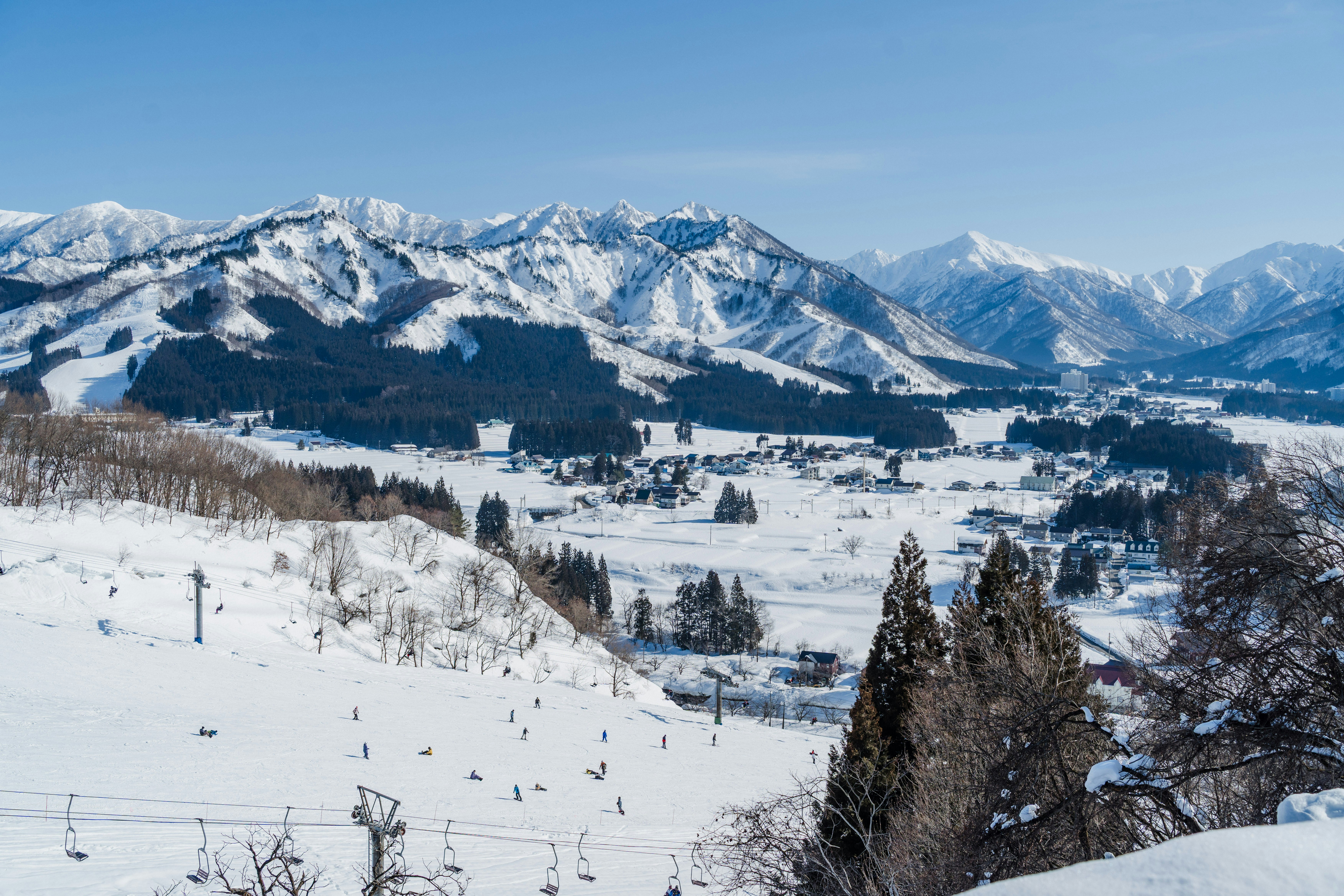 Snowy mountains dominate this wintery landscape scene.