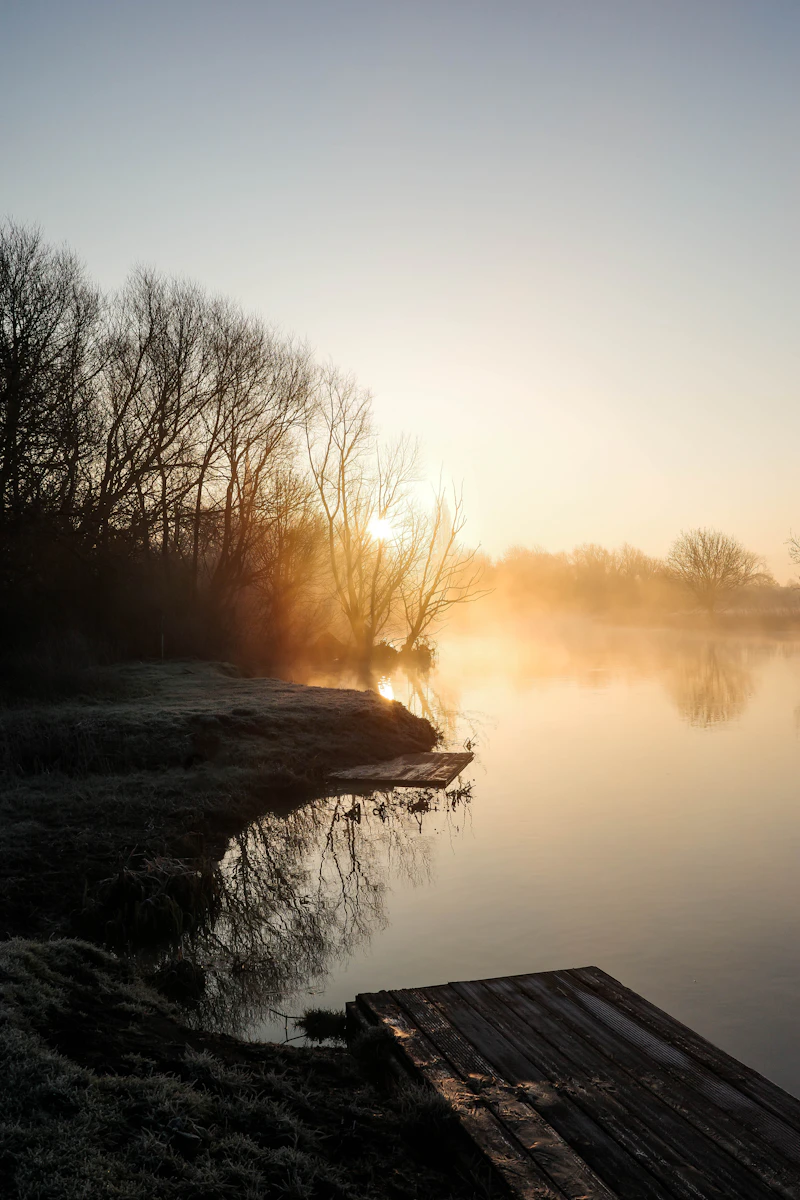Misty morning light over a serene lake