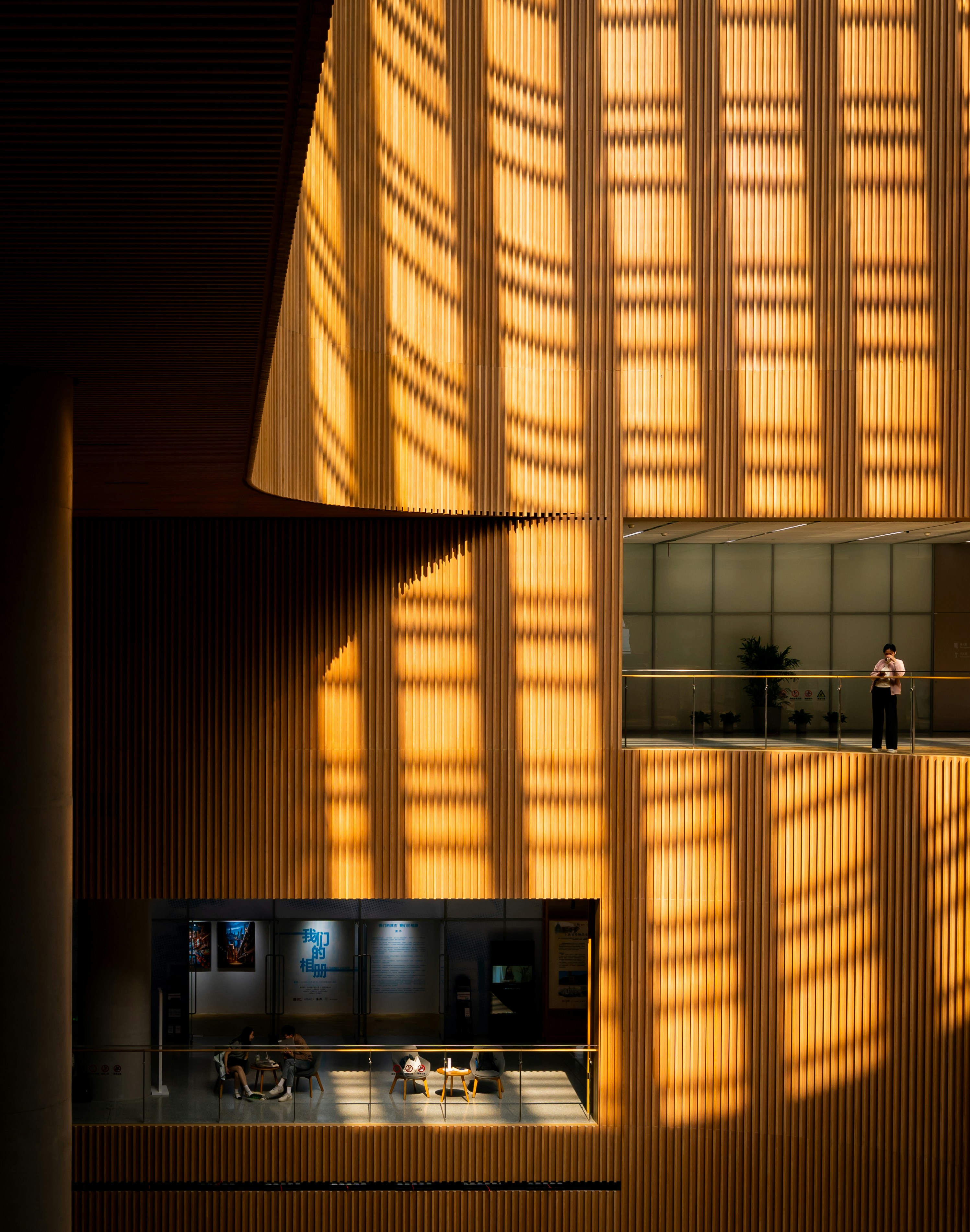 A person standing on a balcony in a building