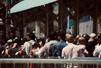 People are waiting in a long, crowded line.