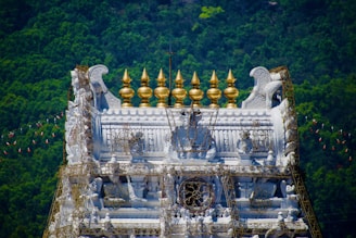 A white temple crowned with golden finials.