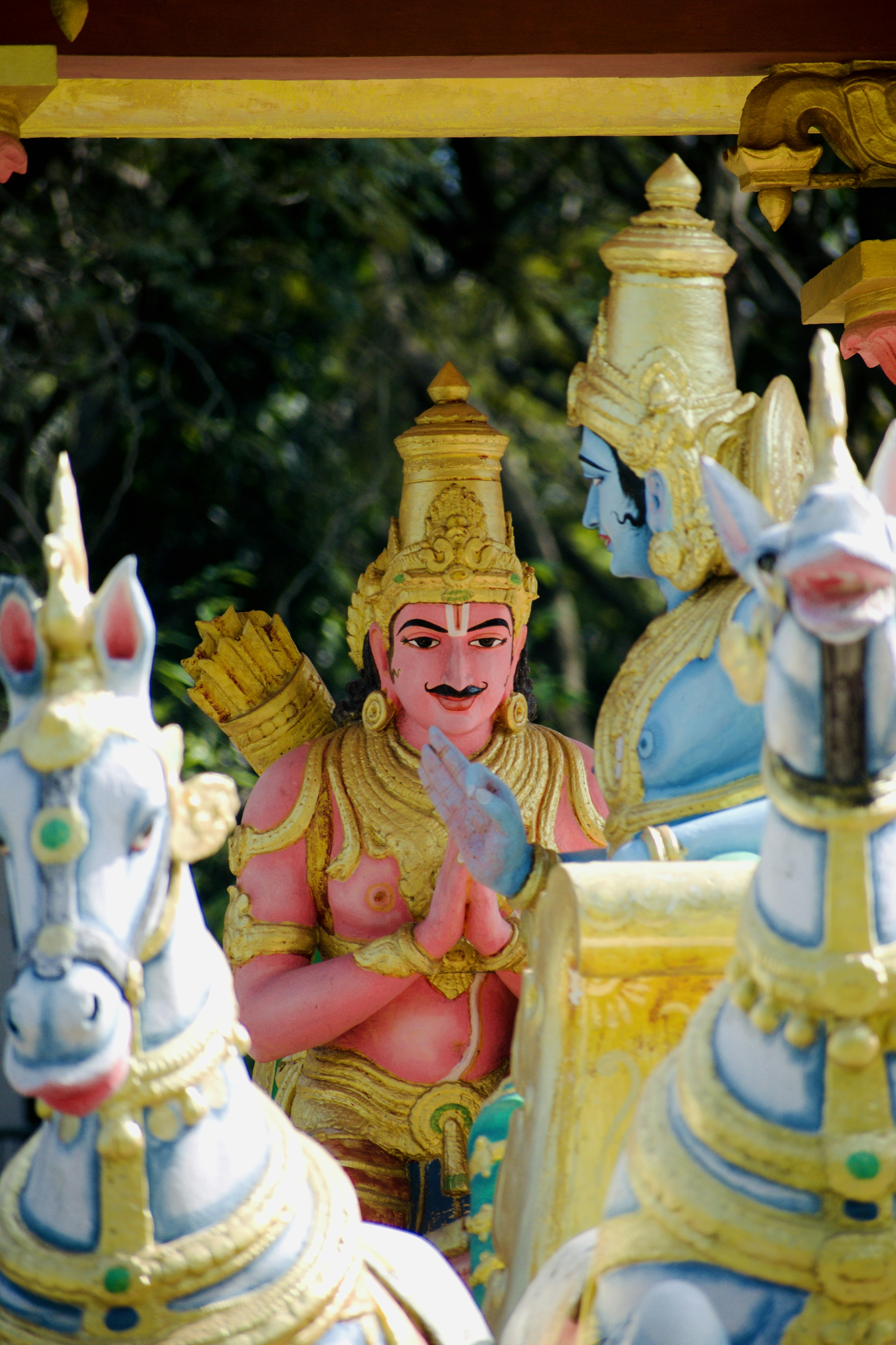 Statues of hindu deities in vibrant colors.