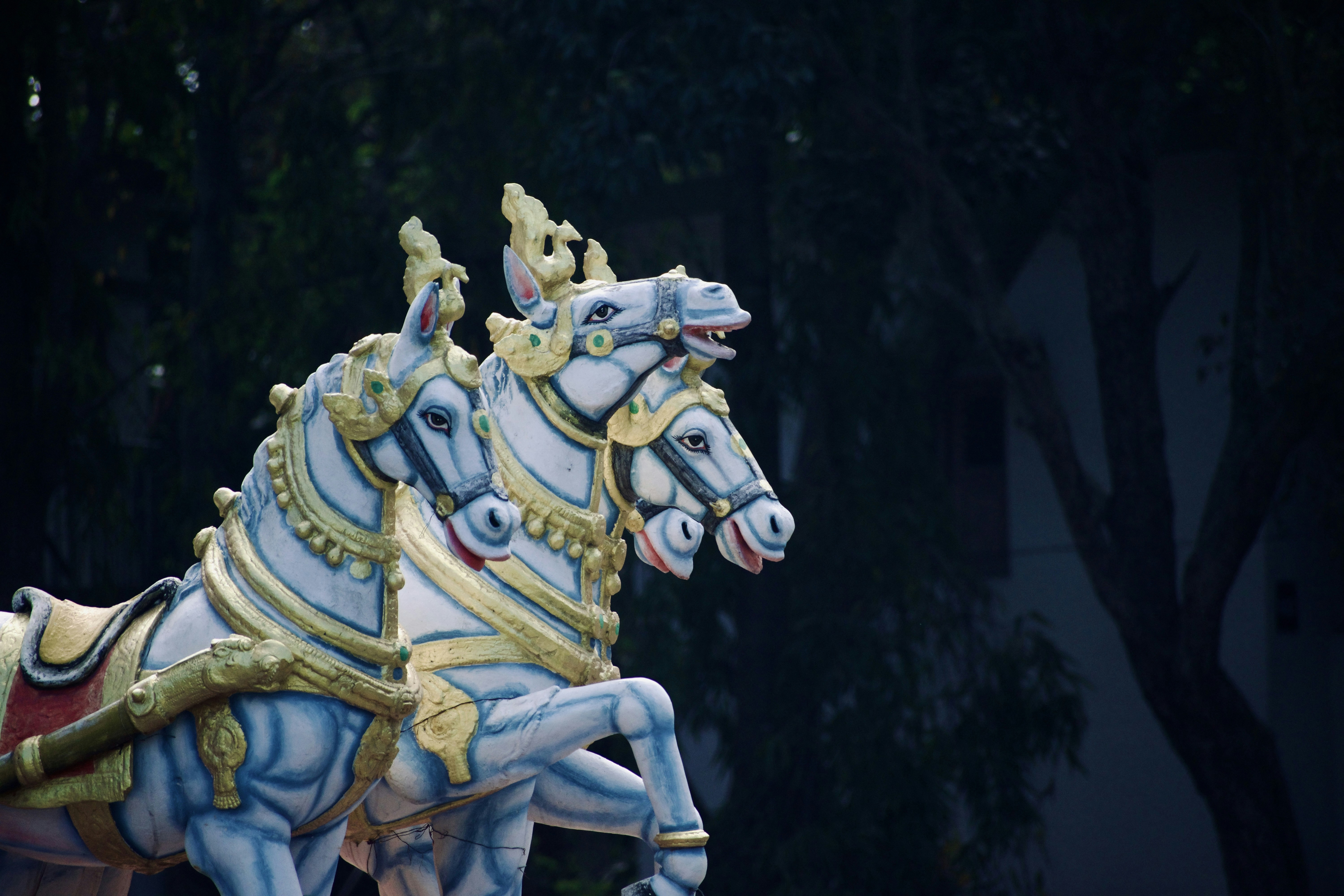 Decorated horse statues stand majestically against the backdrop.