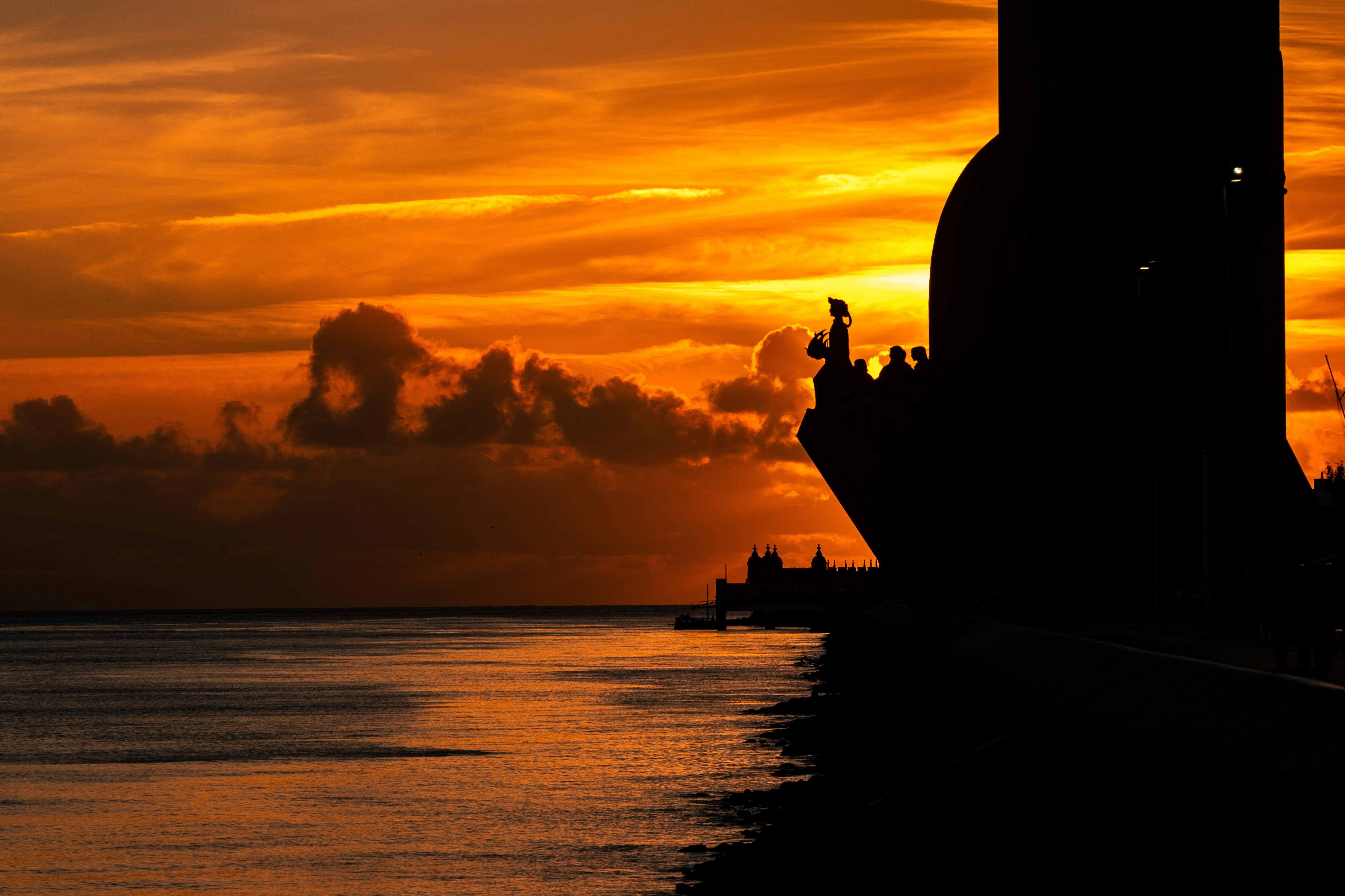 A ship's silhouette at sunset's golden hour.