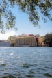 Beautiful building on the water, with some leaves.