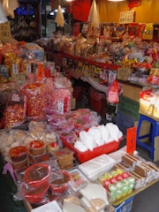 A street market full of various colorful candies.