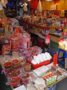 A street market full of various colorful candies.