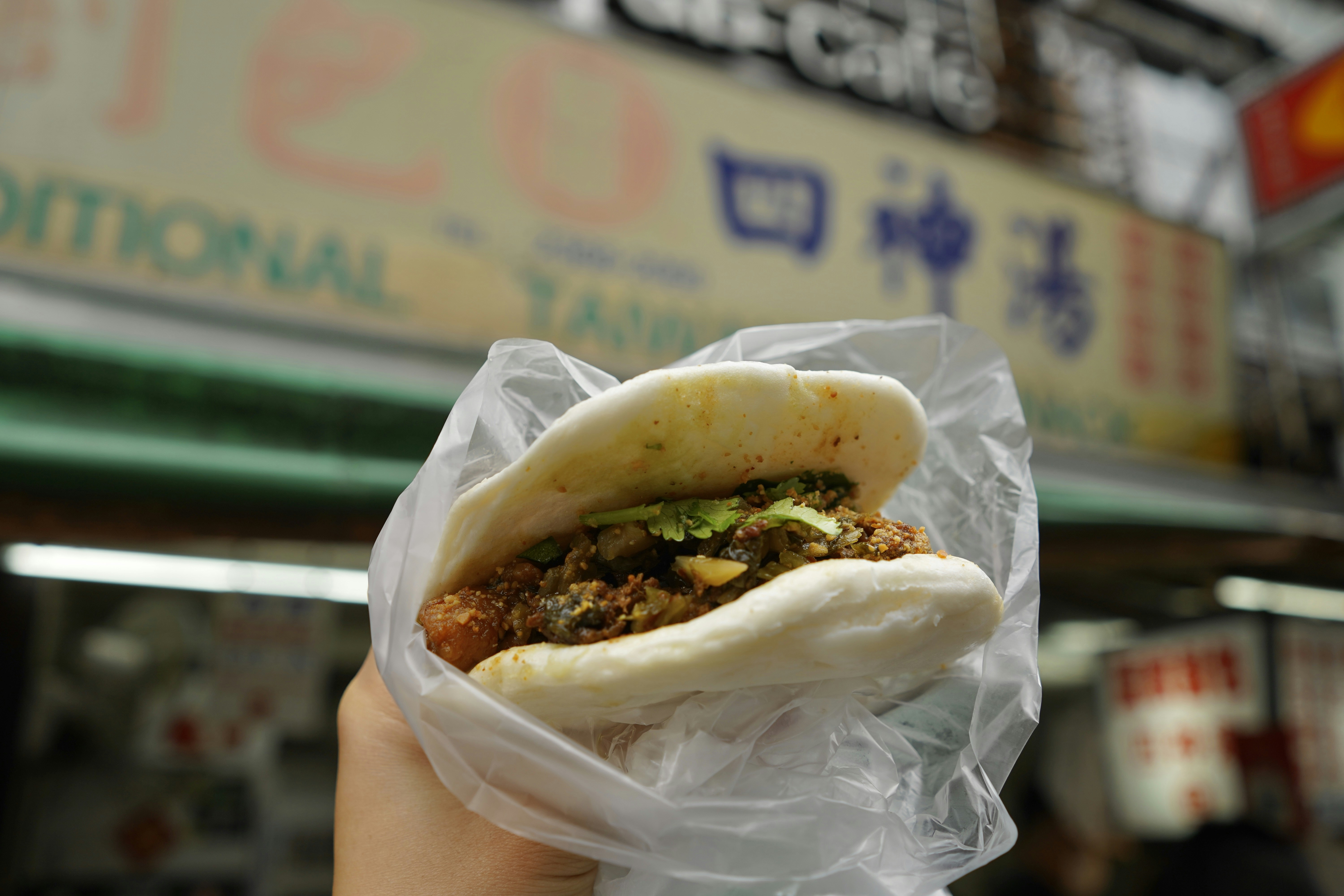 Delicious asian street food bun in plastic.