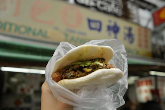 Delicious asian street food bun in plastic.