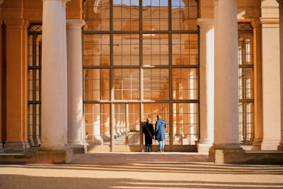 A couple of people standing in front of a building