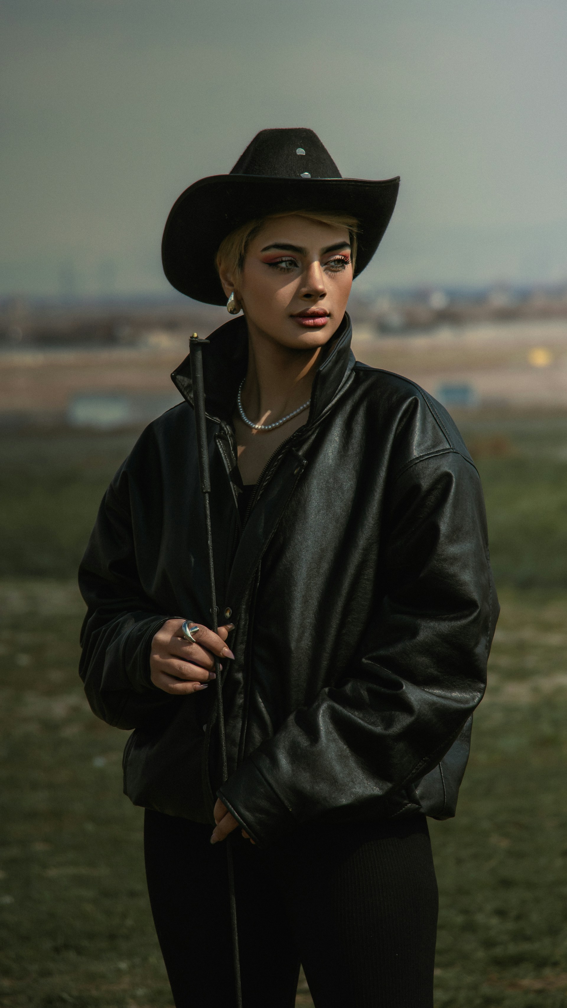 A stylish woman in a black cowboy hat.