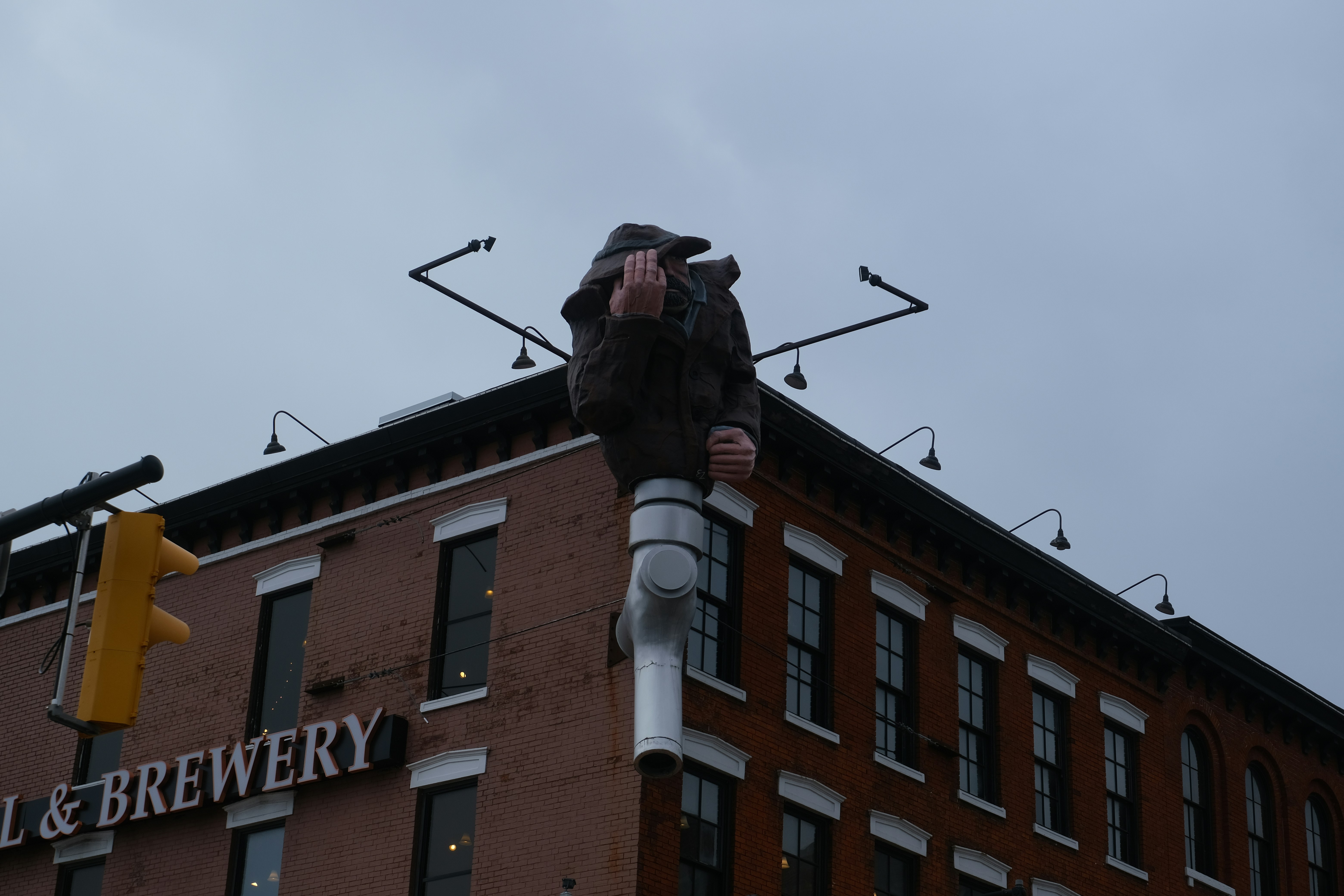 A sculpture sits atop a building.