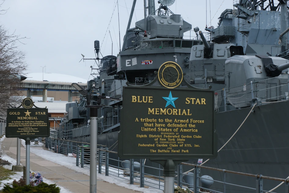A blue star memorial is seen next to a ship.
