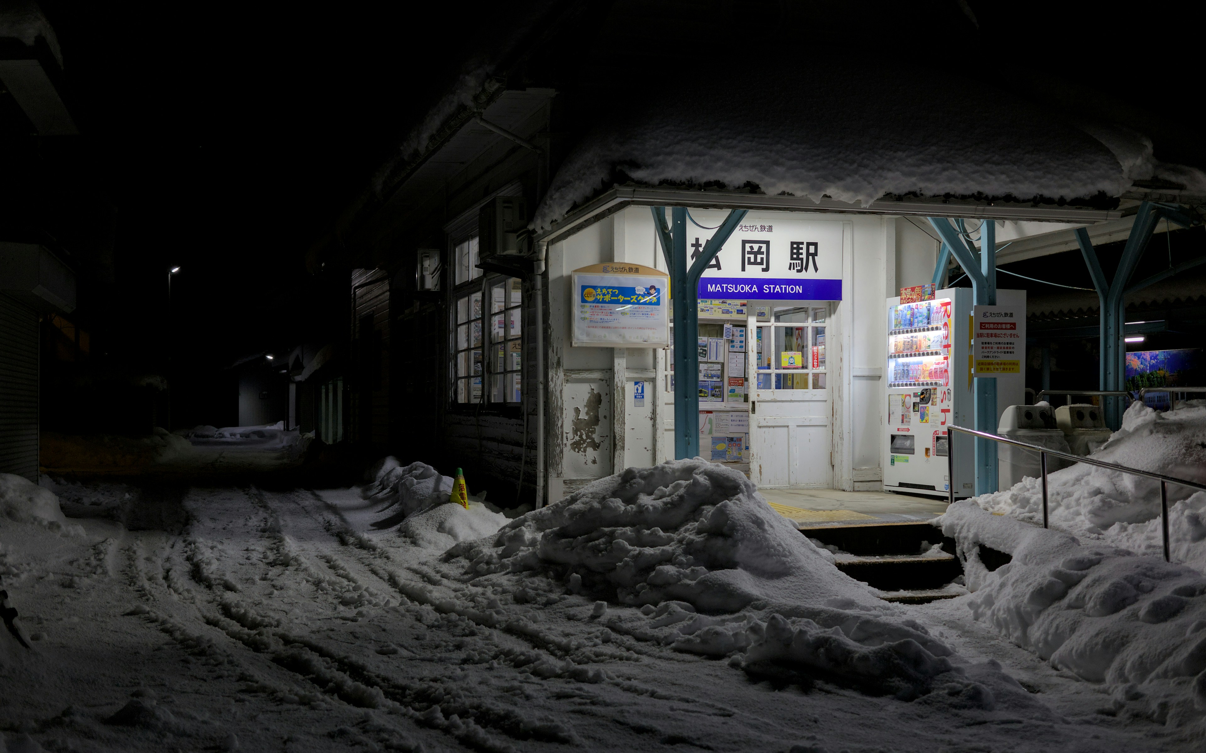 Electric vehicles charging at a public station on a snowy Canadian city street