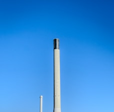 A factory building with a large pipe sticking out of it's side