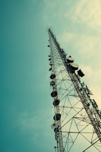 Telecommunication tower against a blue sky.