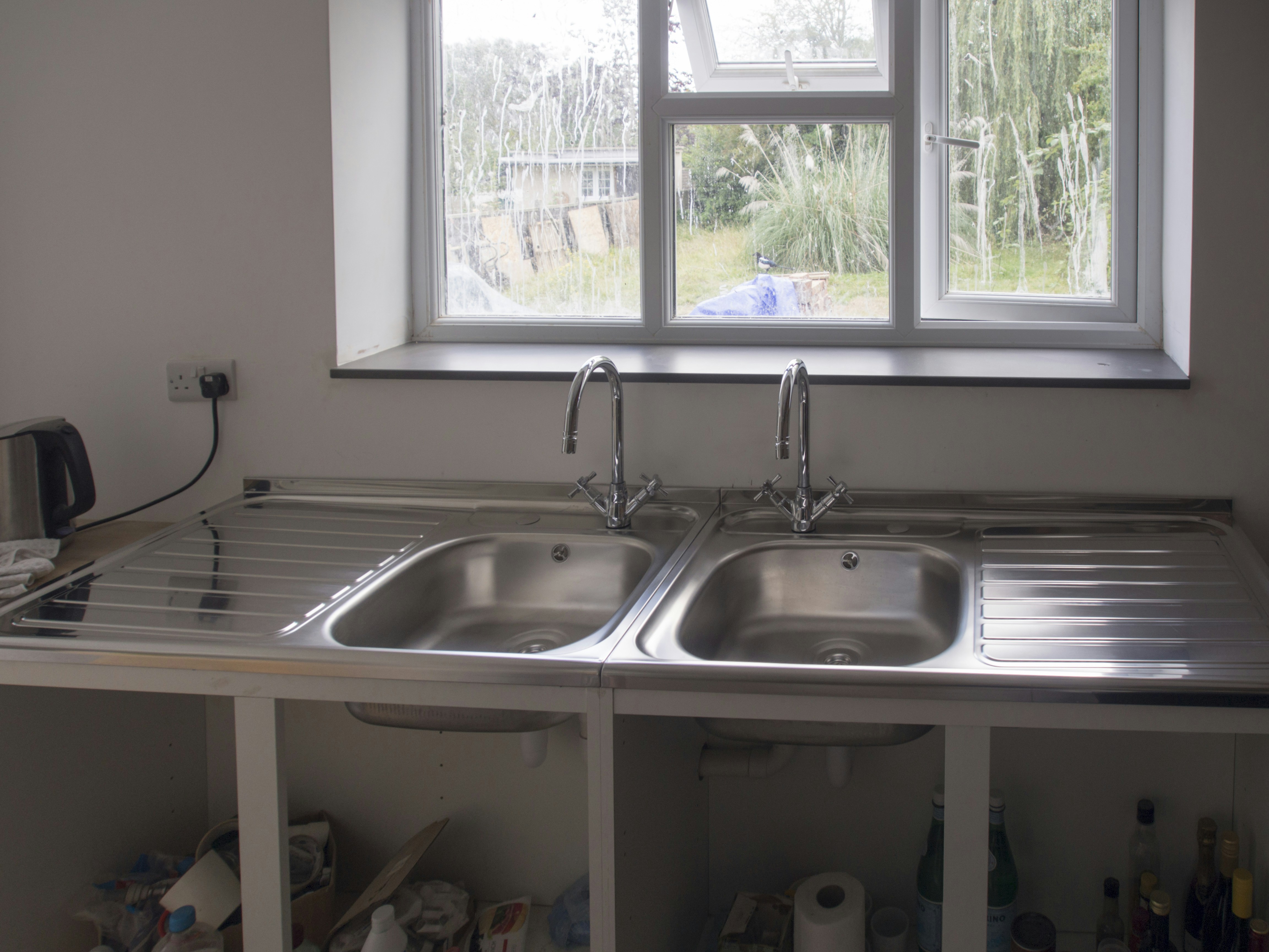 A kitchen with a sink and a window
