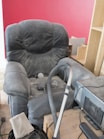 A living room with a couch and a vacuum