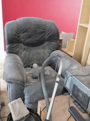 A living room with a couch and a vacuum