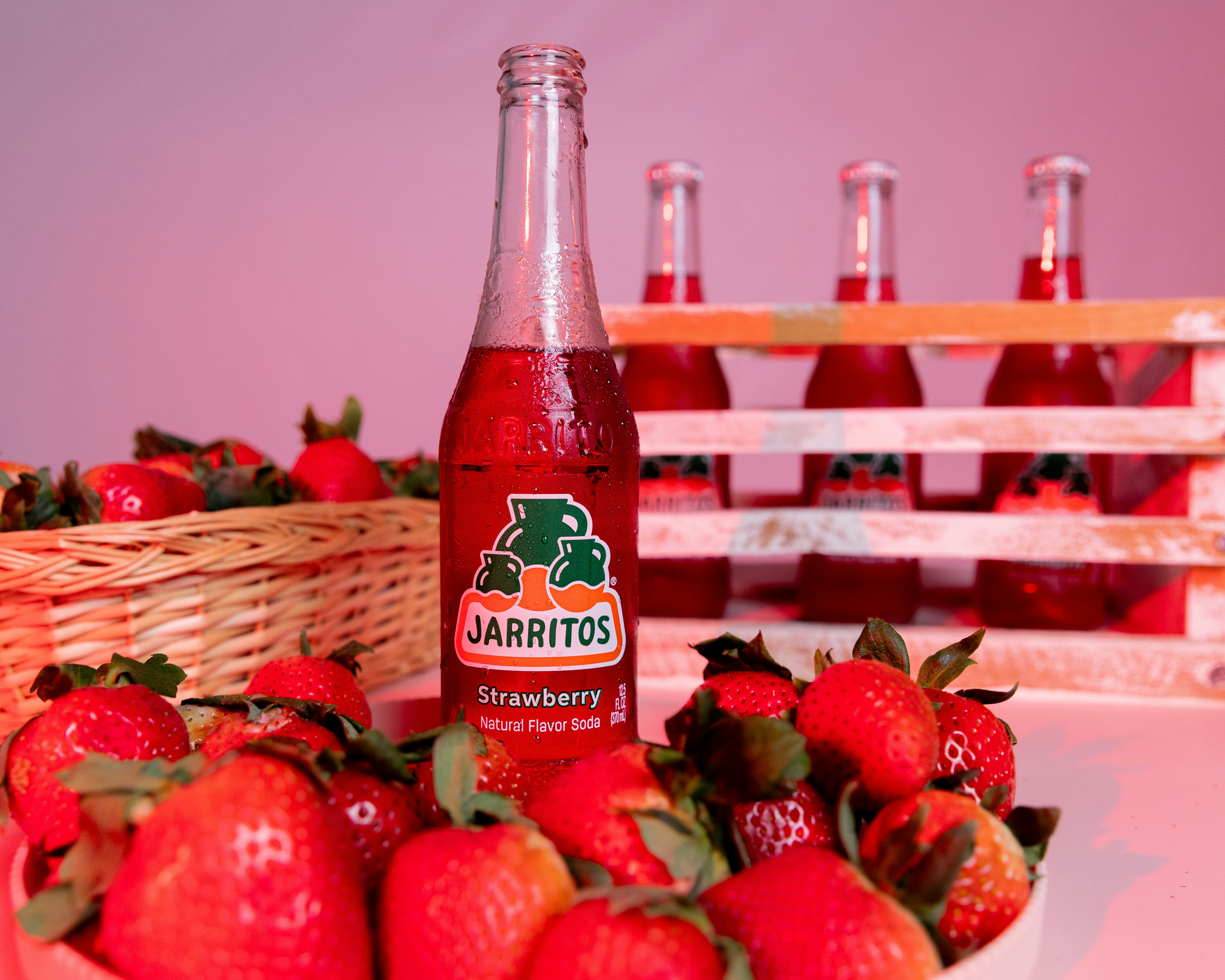 Jarritos strawberry soda with fresh strawberries.