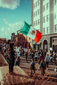 A protester holds a mexican flag during a march.