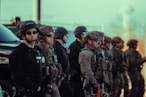 Heavily armed police officers standing in a line.