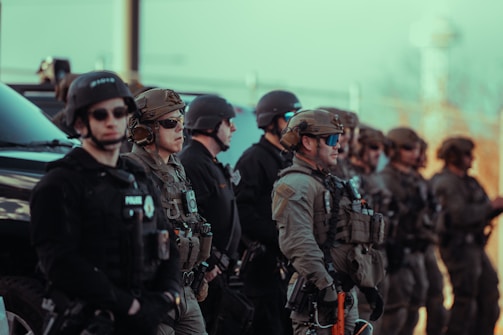 Heavily armed police officers standing in a line.