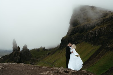 Couple embraces on a mountain for a wedding photo.
