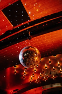 A sparkling disco ball hangs from the ceiling.