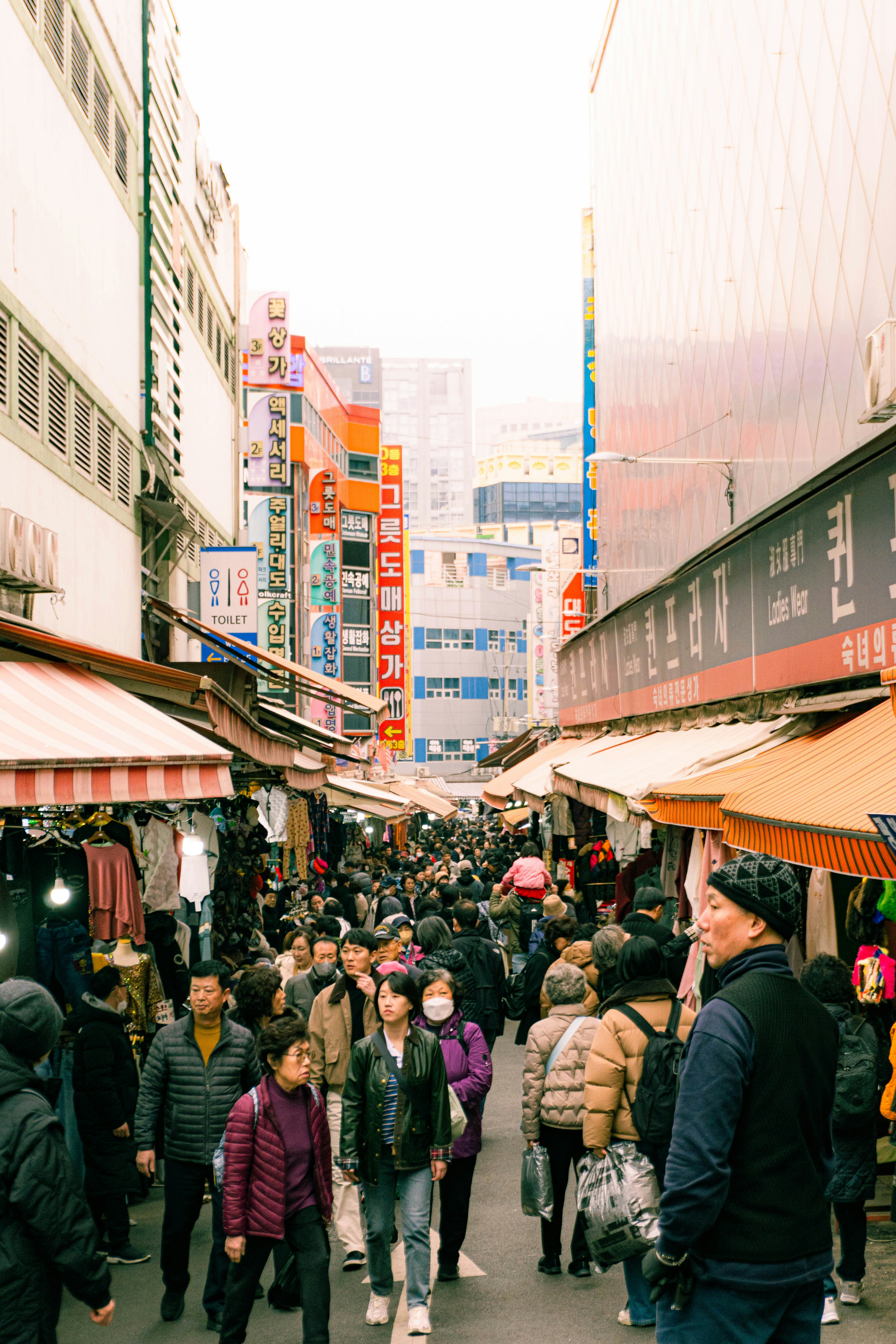 Crowded marketplace street with many people.
