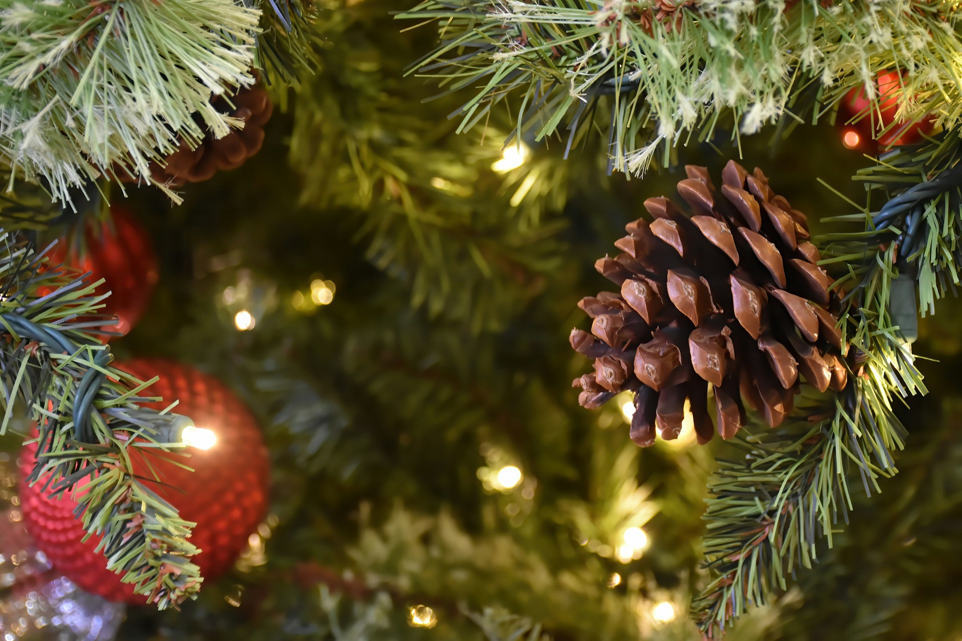 Christmas tree decorated with pinecones and ornaments.