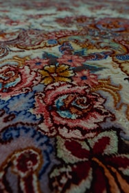 Detailed, floral pattern on a carpet.