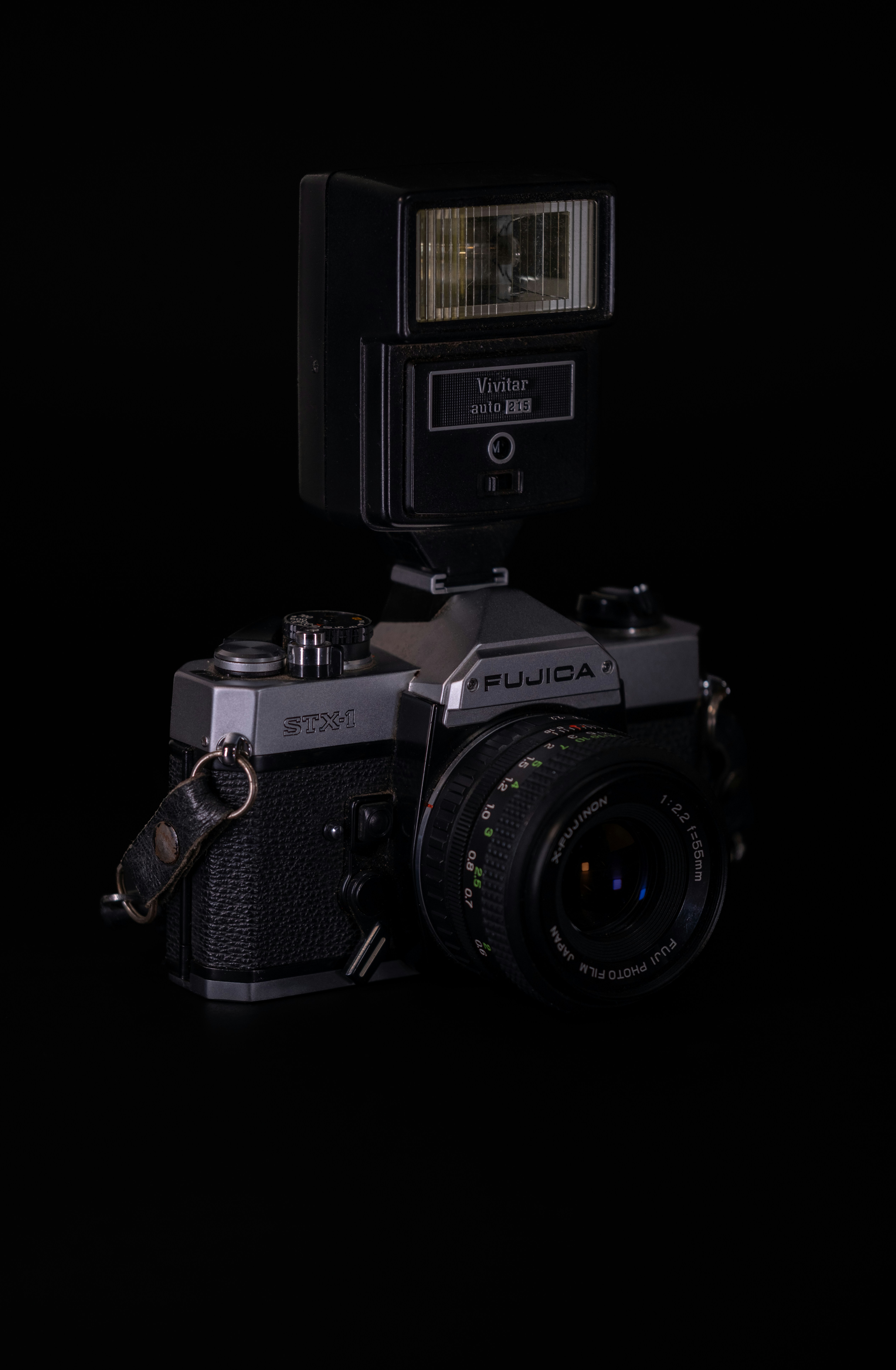 Vintage fujica camera with attached flash.