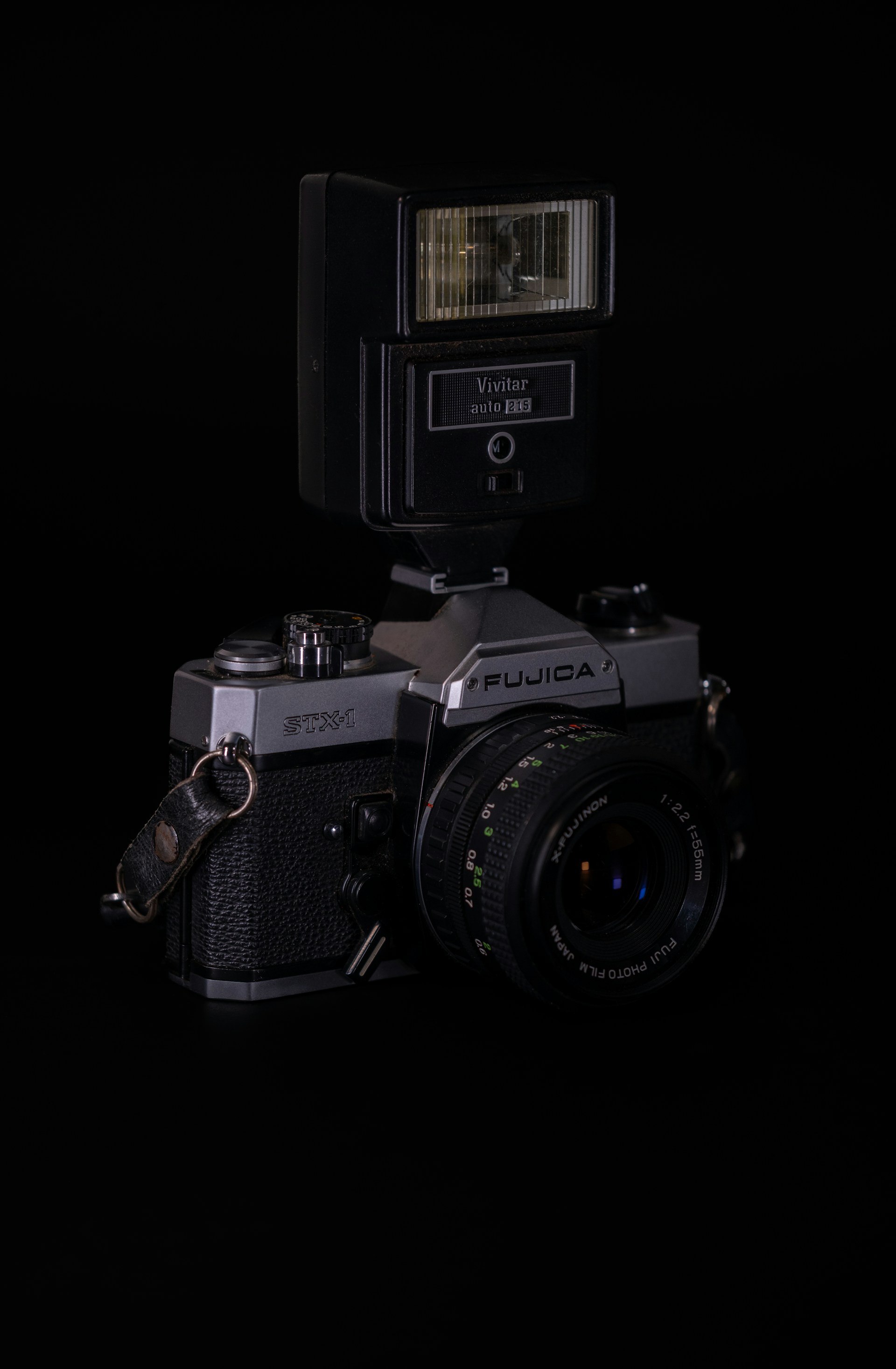 Vintage fujica camera with attached flash.