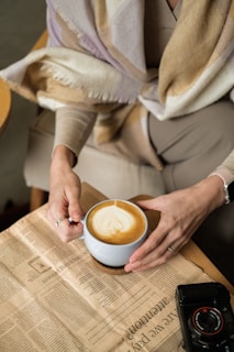 Woman enjoys a latte in a cafe.