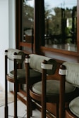 Cozy, vintage bar stools line a window.