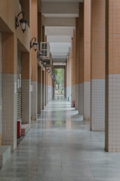 An empty, tiled corridor stretches toward the light.