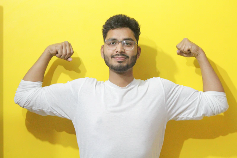 Young man flexes his muscles for the camera.