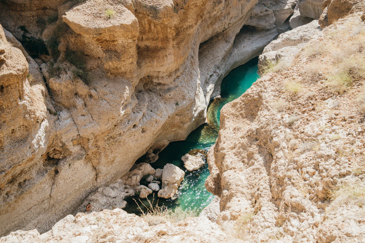 Wadi Shab turquoise swimming pool at the end of a canyon walk in the Hajar Mountains