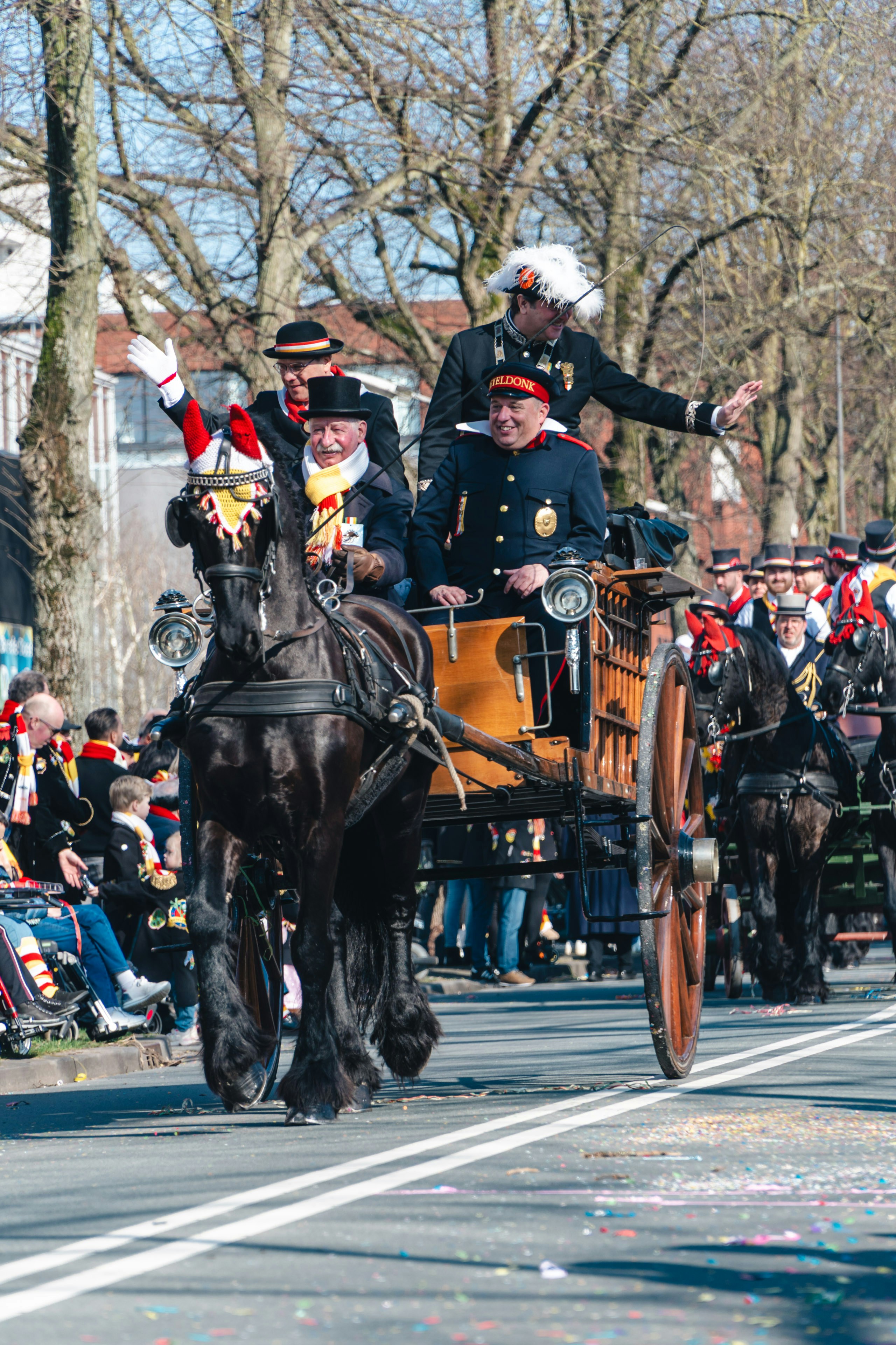 People ride in a horse-drawn carriage in a parade. photo – Free Man ...