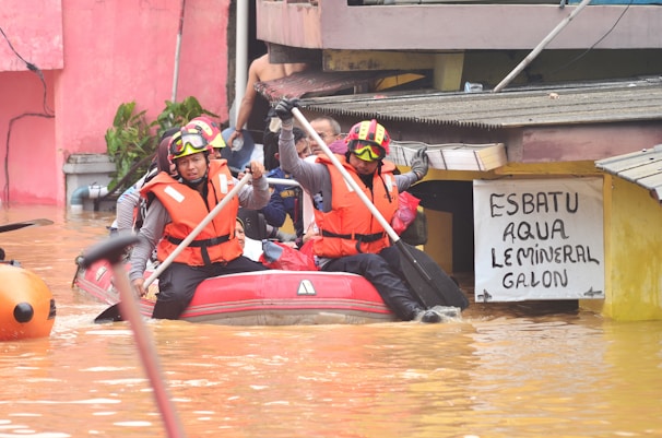 Rescue workers navigate floodwaters in a boat.