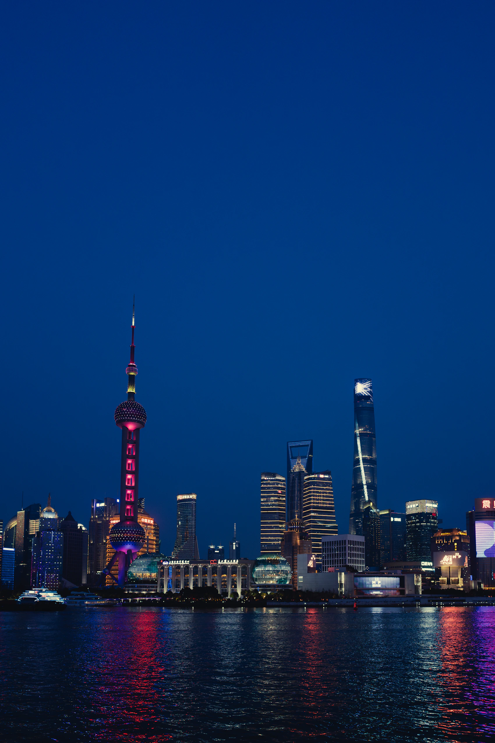 Futuristic Shanghai skyline illuminated beside the Huangpu River, China
