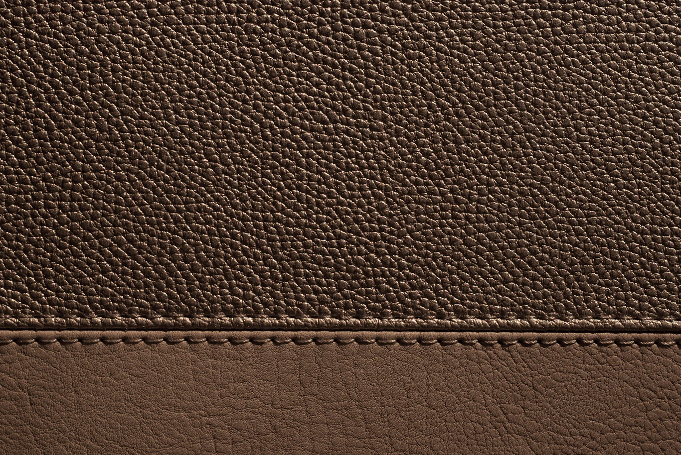 Hand-stitched leather panel showing tight, even saddle stitching