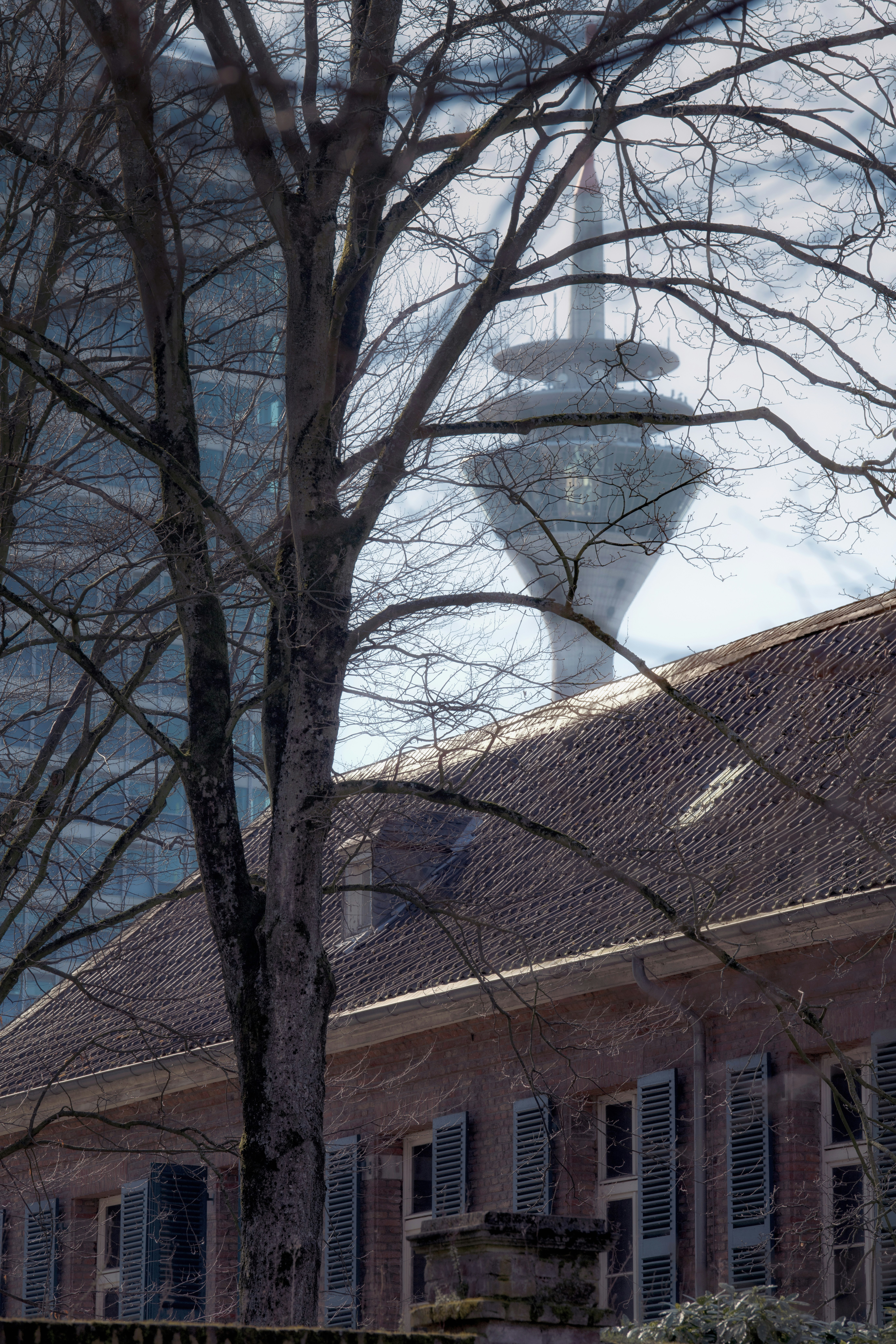 A television tower appears above a red brick building.