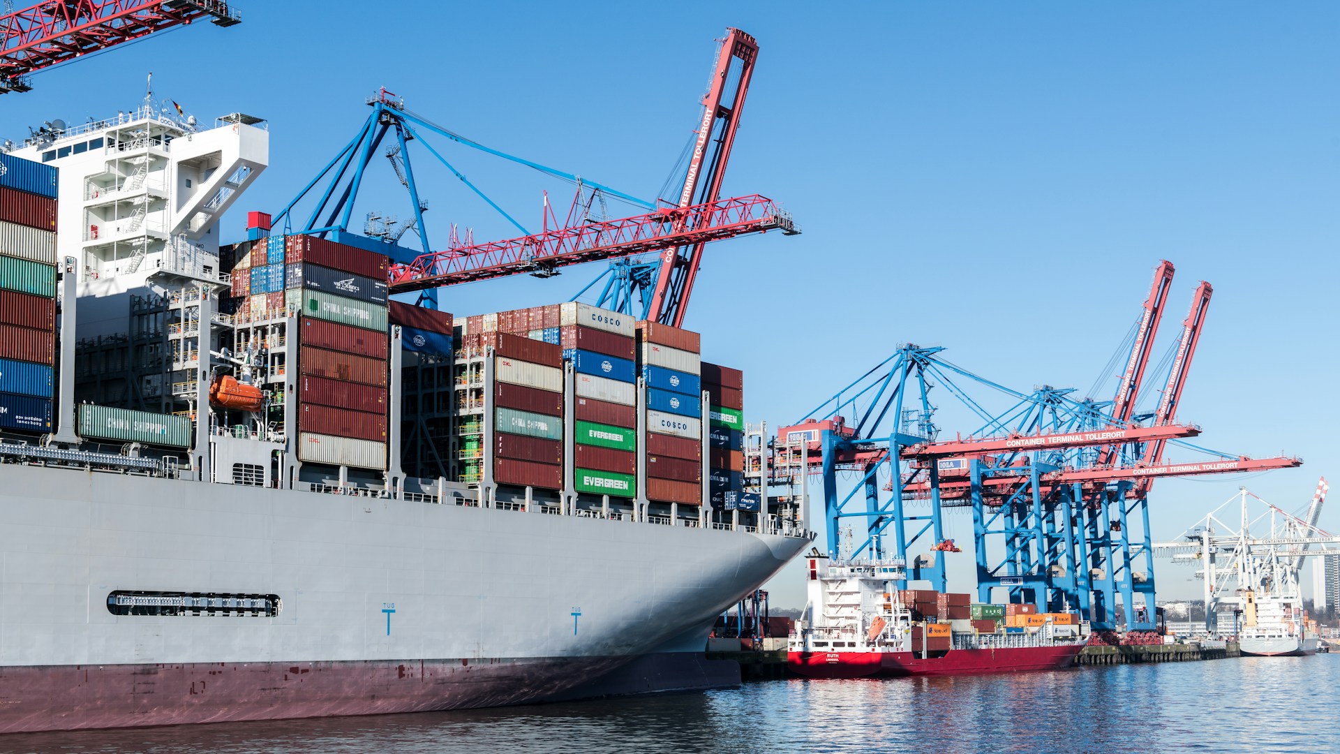 A cargo ship at a busy port.