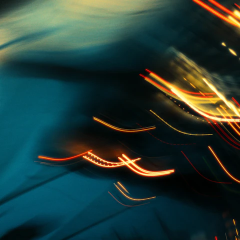 Abstract lines of light streak across darkness.