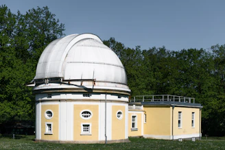 An observatory stands in a park setting.
