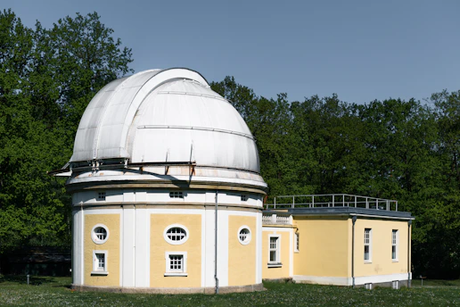 An observatory stands in a park setting.